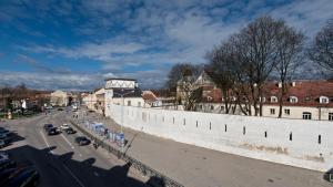 a view of a city with a large white wall at City Entrance Apartment in Vilnius