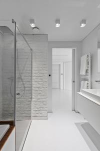 a bathroom with a shower and a sink at City Entrance Apartment in Vilnius
