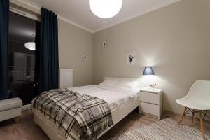 Posteľ alebo postele v izbe v ubytovaní White Swan Apartment