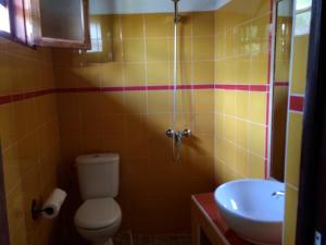 a bathroom with a toilet and a sink at Hôtel Kadiandoumagne in Ziguinchor