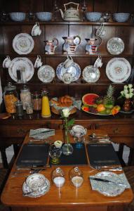 a table with plates and dishes on a shelf at Highbury in Abercych