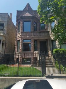 a house with a car parked in front of it at Forrestville Ave Large Suite in Chicago