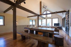 a large room with wooden tables and chairs at Moiwa Chalet Niseko in Niseko