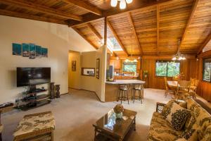 a living room with a couch and a table at Hale Mauna Loa Upper Level with shared Hot Tub in Volcano