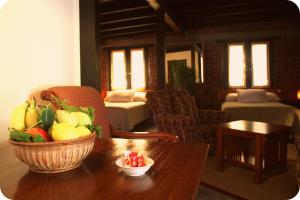 a room with a table with a basket of fruit on it at Las Orquideas in Valle de Guadalupe