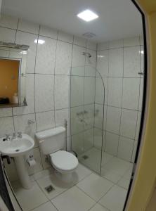 a bathroom with a shower and a toilet and a sink at Hospedaje Jose Gorgues in Puerto Iguazú