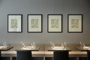 a dining room with a table with four pictures on the wall at Shilla Stay Gangnam Yeoksam in Seoul +39 photos