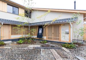 a building with a courtyard in front of it at Shioriya in Nagano