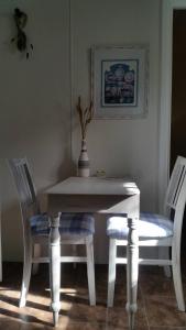 a white table and chairs with a vase on top at Padthaway Caravan Park in Padthaway