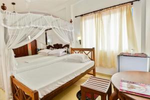 Postelja oz. postelje v sobi nastanitve Hotel Dolphin Hikkaduwa