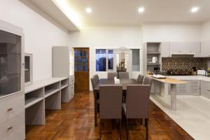 a kitchen and dining room with a table and chairs at Cozy Home by Nan in Chiang Mai