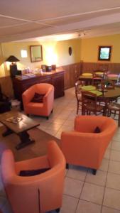 un restaurante con mesas y sillas naranjas en Relais du Volcan, en La Plaine des Cafres