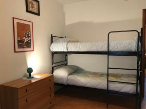 a bedroom with two bunk beds and a dresser at Alloggio turistico La Condemine VDA Introd CIR 0001 in Introd