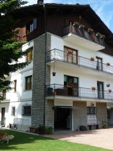 a large white building with windows and balconies at Alloggio turistico La Condemine VDA Introd CIR 0001 in Introd
