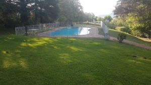 a fence around a swimming pool in a yard at Lairds Lodge in Underberg