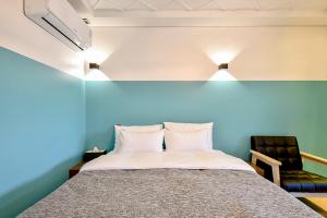 Ulsan Hotel 109 tesisinde bir odada yatak veya yataklar
