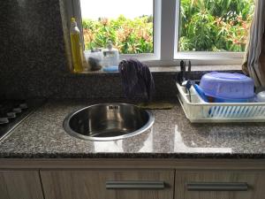 a kitchen counter with a sink and a window at Br Court Apartments in Quatre Bornes +148 photos