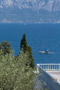 a boat in a large body of water at Porto Galini Seaside Resort & Spa in Nikiana