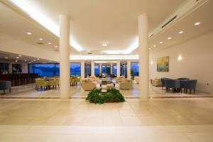 a lobby with couches and tables and chairs at Porto Galini Seaside Resort & Spa in Nikiana +37 photos