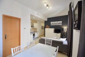 a living room with a couch and a table and a kitchen at Quart Youth Hostel & Apartments in Valencia