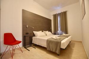 a bedroom with a bed and a red chair at Quart Youth Hostel & Apartments in Valencia