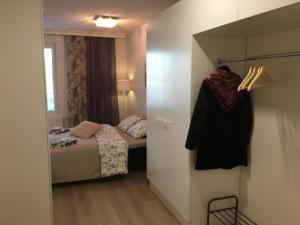 a small bedroom with a bed and a closet at Lahti City Home in Lahti