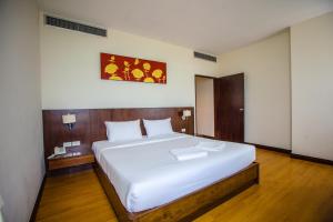 Una cama o camas en una habitación de Grande Southern Hotel