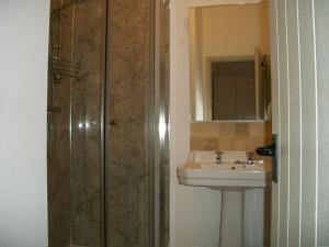 a bathroom with a sink and a shower at Middletown Farmhouse B&B in Okehampton