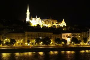 a view of a city at night with a building at Diana’s Charming Studio at the Buda Castle in Budapest