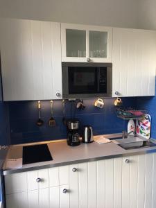 a kitchen with white cabinets and a counter top at Diana&rsquo;s Charming Studio at the Buda Castle in Budapest