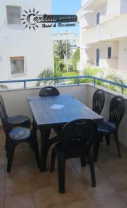 a black table and chairs on a balcony at Appartamenti Baia Verde Gallipoli di Carlino Tourist in Gallipoli