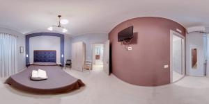 a large bedroom with a large bed and a tv at BebNonnaMaria1928 in Salerno