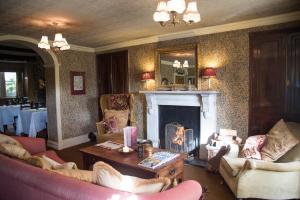 a living room with two couches and a fireplace at The Traddock in Austwick
