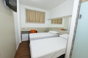 Ένα ή περισσότερα κρεβάτια σε δωμάτιο στο Hotel Panorama Economic