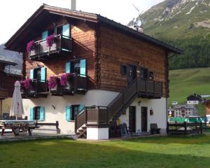 a building with stairs and balconies on it at Art Apartments Kandinsky in Livigno