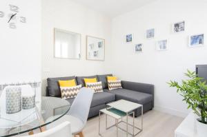 a living room with a couch and a table at Minty Stay - Jose Ortega y Gasset in Madrid