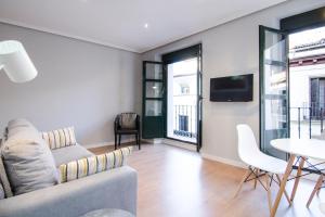 a living room with a couch and a table at Estudios 8 in Madrid