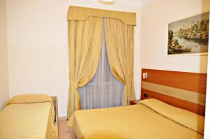 Postel nebo postele na pokoji v ubytování Hotel Moscatello