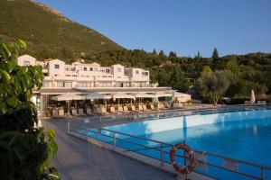 a resort with a large swimming pool and a mountain at Porto Galini Seaside Resort & Spa in Nikiana