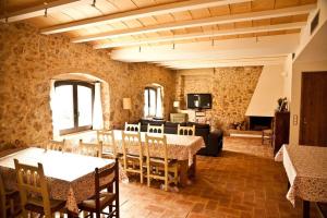 a room with tables and chairs and a living room at Can 28 in Torroella de Montgrí