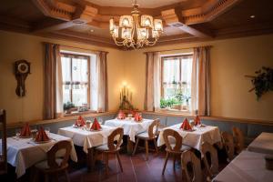 a dining room with tables with red napkins on them at Landgasthof Linden in Linden +18 photos