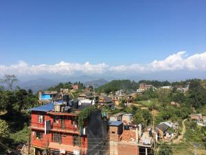 a city with houses and mountains in the background at Shrestha Hotel & Restaurant in Bandipur