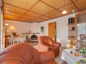 a living room with two leather chairs and a table at Tranquil Holiday Home in Zingst Germany with Terrace in Zingst