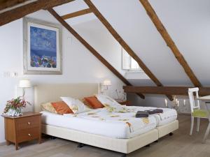 a bedroom with a large white bed in a attic at Dubrovnik Luxury Apartments in Dubrovnik
