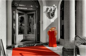 a statue of a woman in a red dress in front of a building at Hôtel Le Royal Promenade des Anglais in Nice
