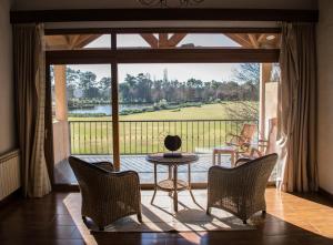 a room with a large glass door leading to a patio at San Ceferino Hotel & Spa in Open Door