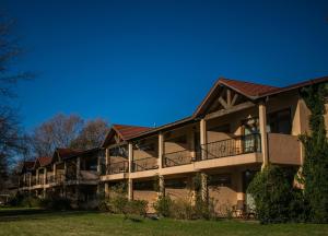 a large apartment building with balconies and a blue sky at San Ceferino Hotel & Spa in Open Door