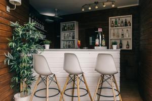 a bar with three stools in front of a counter at Velamar Boutique Hotel - Adults Friendly in Albufeira +29 photos