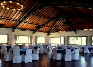 a banquet hall with blue tables and white chairs at San Ceferino Hotel & Spa in Open Door +96 photos