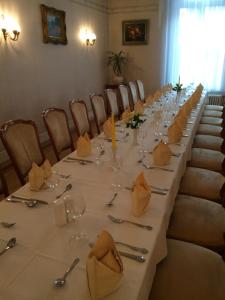 a long table with glasses and napkins on it at Hotel Alt-Karow in Berlin